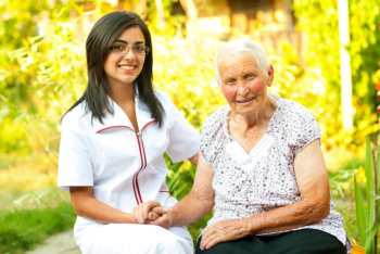 nurse and elderly woman outdoor smiling