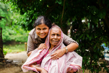 caregiver and elderly woman smiling