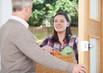 caregiver handling groceries to her patient